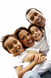 Parents hugging and holding two small children