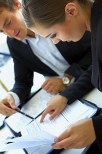 Two colleagues reviewing reports